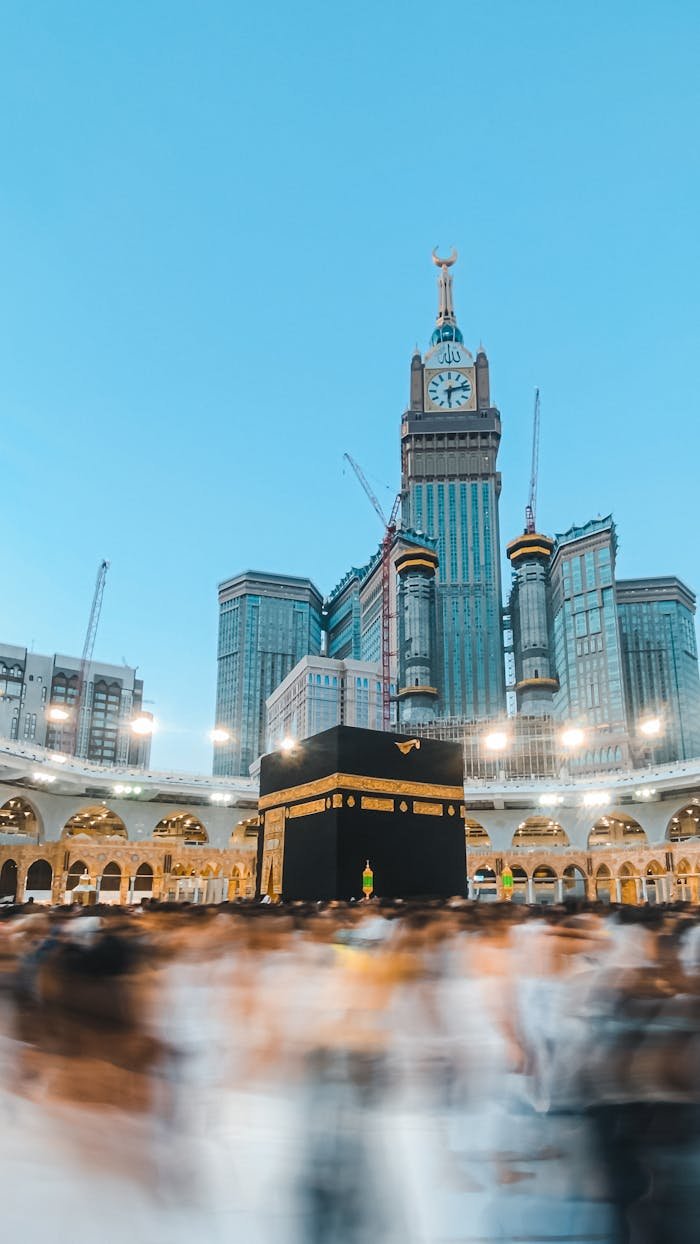 A stunning view of the Kaaba surrounded by blurred worshippers in Mecca's Grand Mosque.